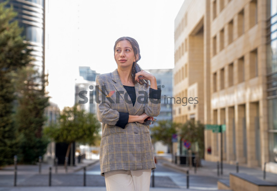 Professional Woman Smiling and Reflecting on Business Opportunities in Al Abdali, Amman Boulevard