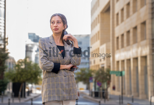 Professional Woman Smiling and Reflecting on Business Opportunities in Al Abdali, Amman Boulevard