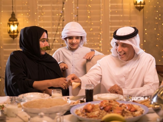 Grandparents giving food to child |-