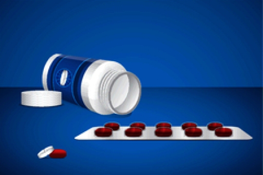 pill bottle with pack of pills on blue