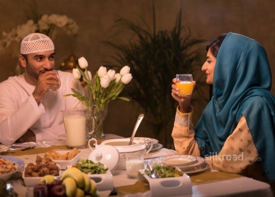 Arabic couple having drinks|-