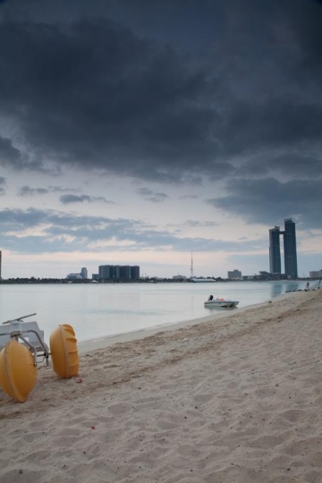 beach sand view with a city
