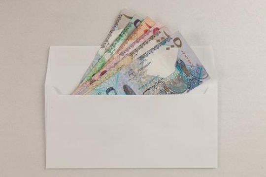 qatri riyals in an envelope