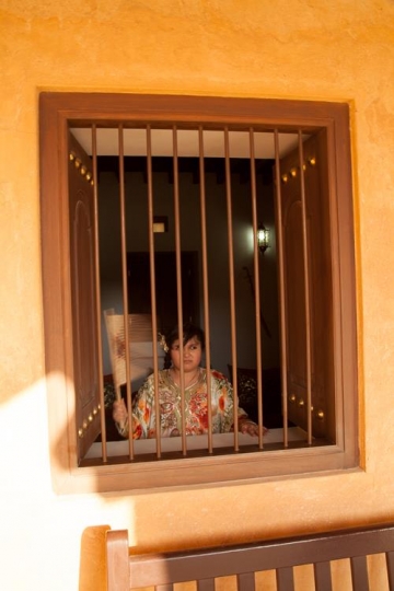 woman standing behind bars