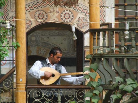 man playing lute 