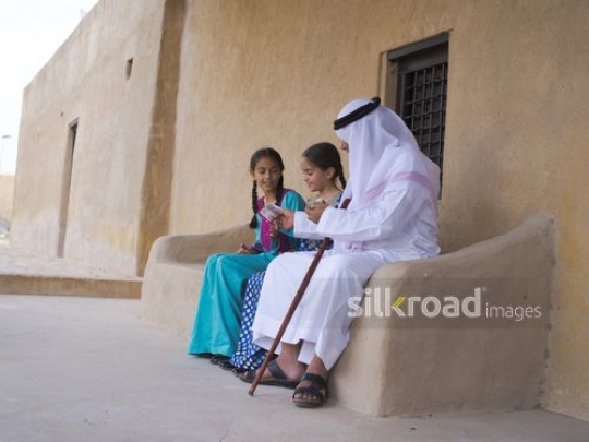 Old man giving money to granddaughters|-