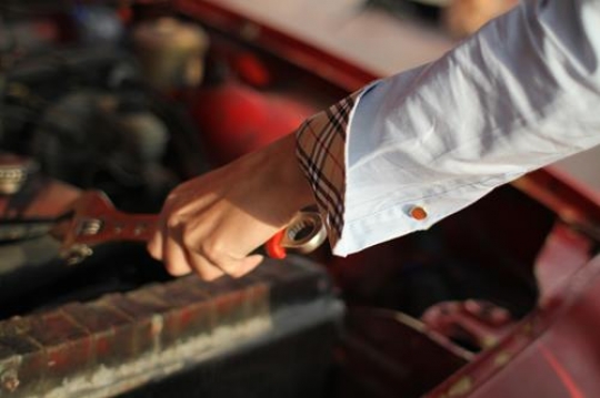 woman mechanic repair broken red car 