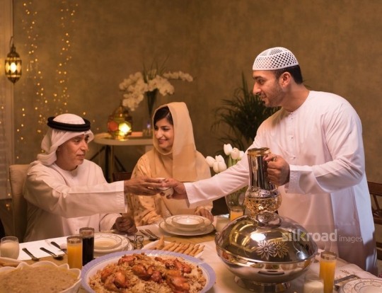father serving grandfather Arabic coffee|-