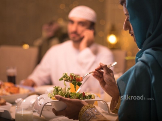 Wife serving oriental salad|-