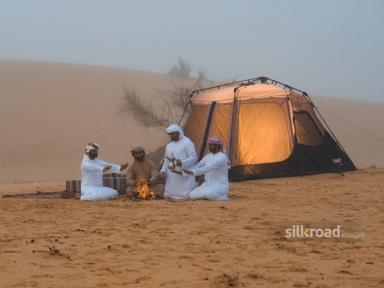 Friends gathered around fire