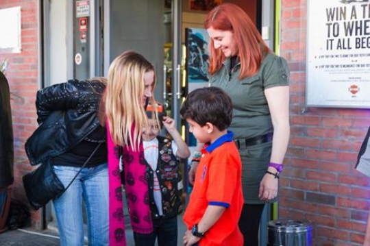 two pretty woman talking to a little boy