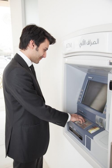 man at automatic teller machine