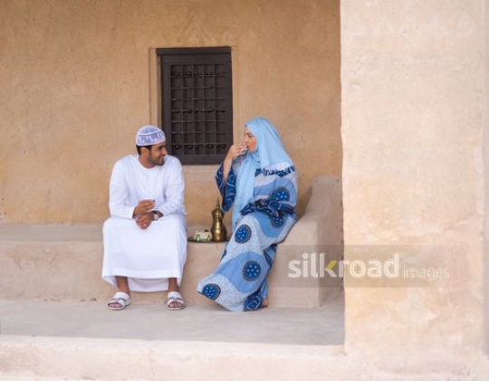 Woman drinking coffee with husband|-