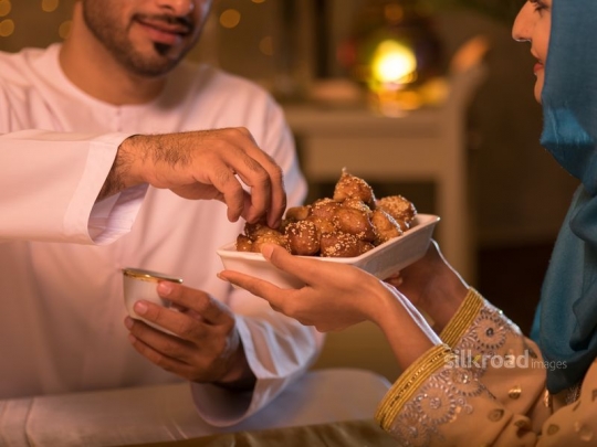 Husband taking arabic sweets|-