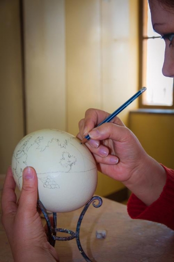 woman painting Ostrich eggs
