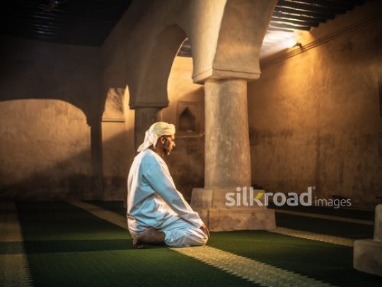 Old man praying at the mosque|-