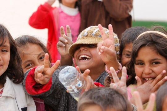 Syrian Kid show victory sign from Zaatari refugee camp for Syrian refugees