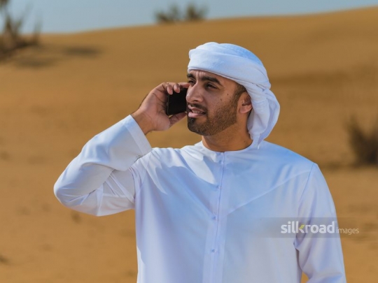 Man talking over mobile in the desert