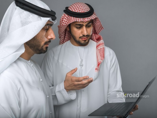 Middle Eastern man explaining to manager
