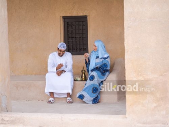 Couple drinking Arabic coffee outside|-