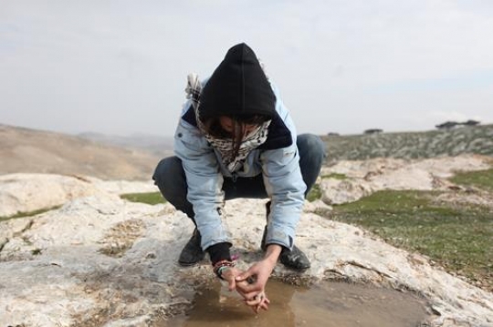 Palestinian demonstrators wash