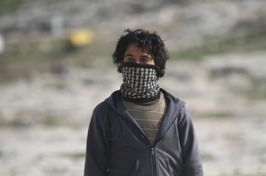 Young Palestinian demonstrators masked at Bab al-Shams or Gate of the Sun