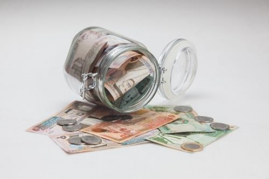 jordanian currency inside glass jar