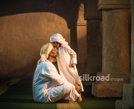 Boy kissing grandfather agh the mosque|-