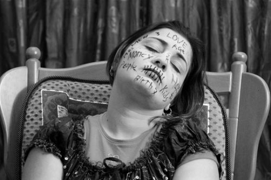 black and white image for woman with words written on her face