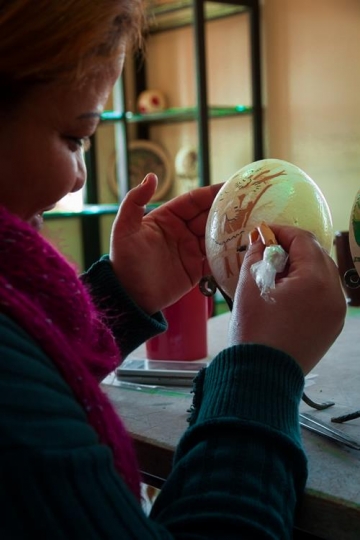 woman painting Ostrich eggs