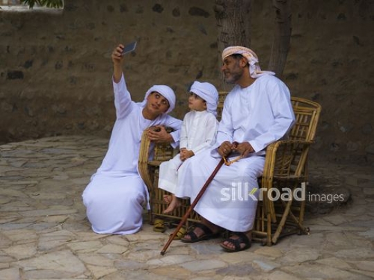 Kids taking selfie with grandfather|-
