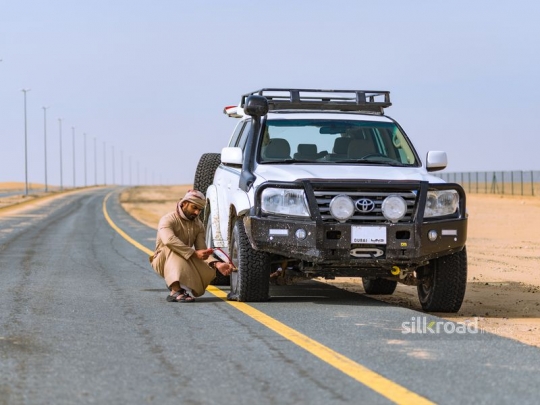 man fixing the car on the road