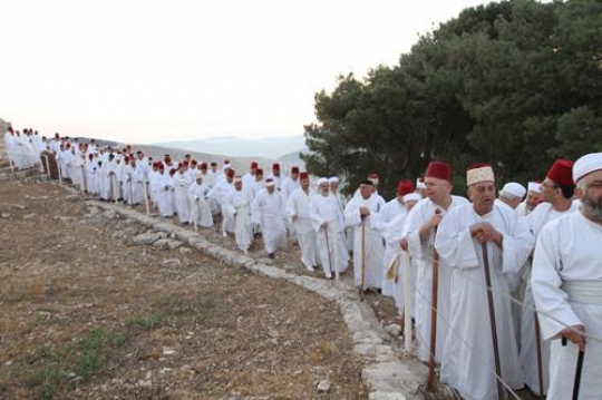 members of the Samaritan community march atop Mount Gerizim, above the West Bank city of Nablus,