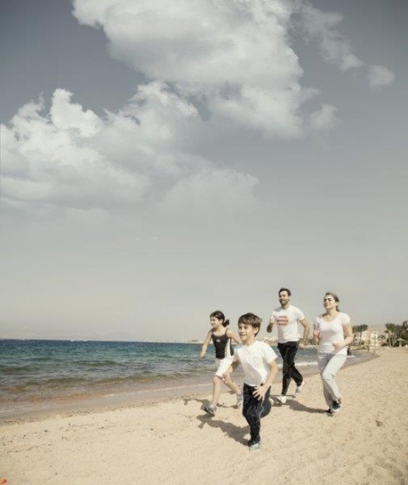 Family Running by the Sea