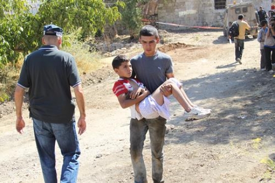 young man holding injured boy