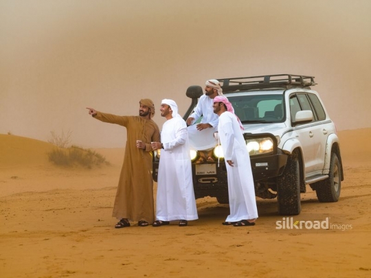 Men stopping in the desert