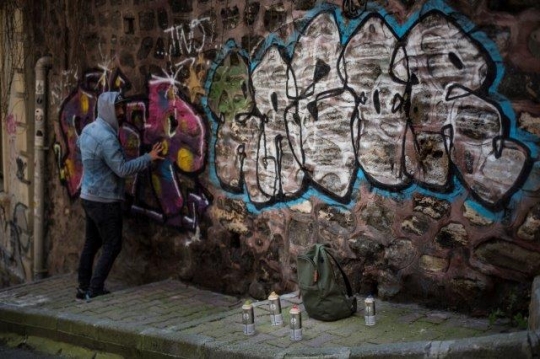 Graffiti Guy Spraying on Wall 