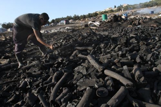 A man picking up lumber 