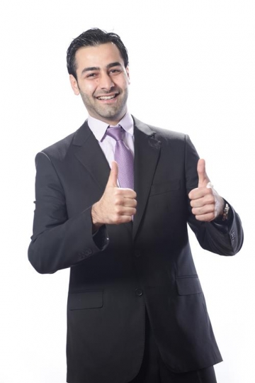 Cheerful businessman making thumbs up