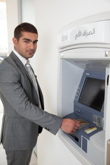 handsome man at automatic teller machine