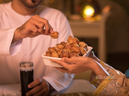 Taking Arabic sweets|-