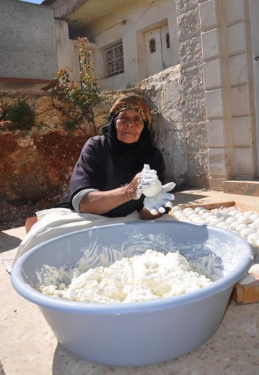 senior woman kneading dough