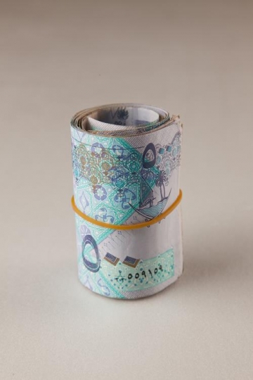 qatari riyals rolled up