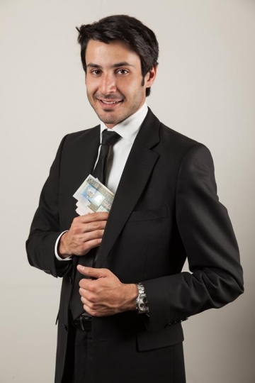 businessman putting money in his jacket pocket