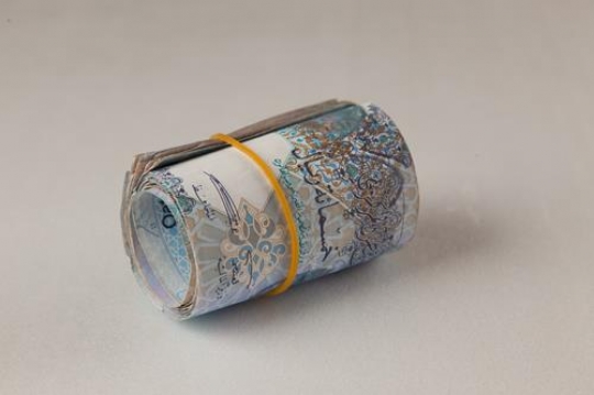 qatari riyals rolled up