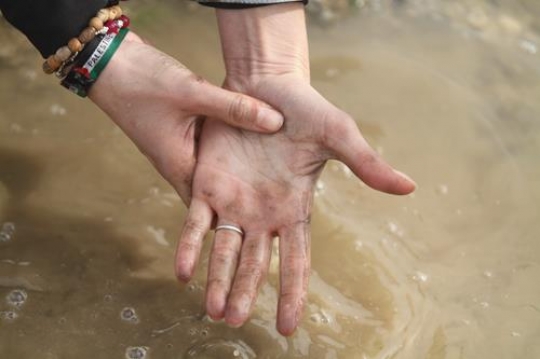 Palestinian demonstrators washing her hands at Bab al-Shams or Gate of the Sun