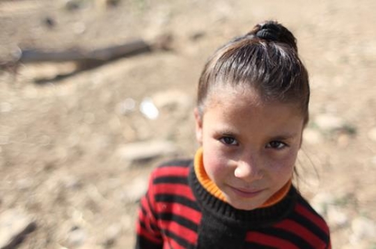 Cute little girl is playing with her brothers.