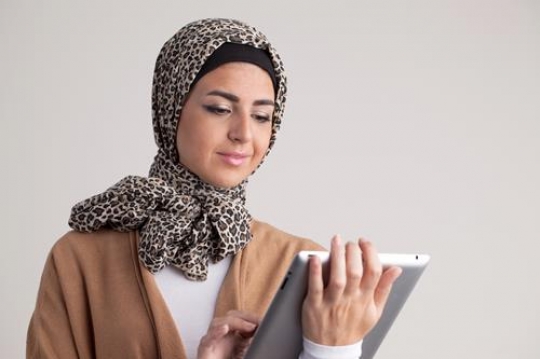 young woman holding ipad