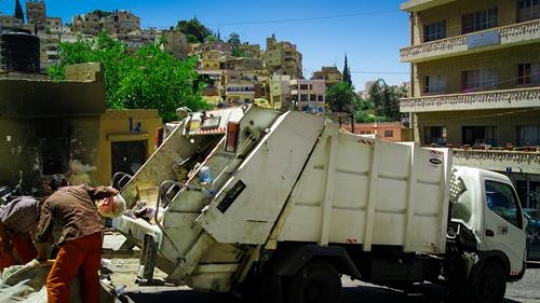 worker of urban municipal recycling garbage collector truck