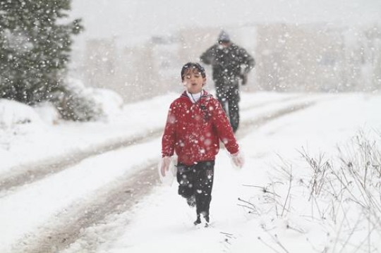 Fresh snow cover, at winter in Palestine, everbody happy and outside and play in the snow